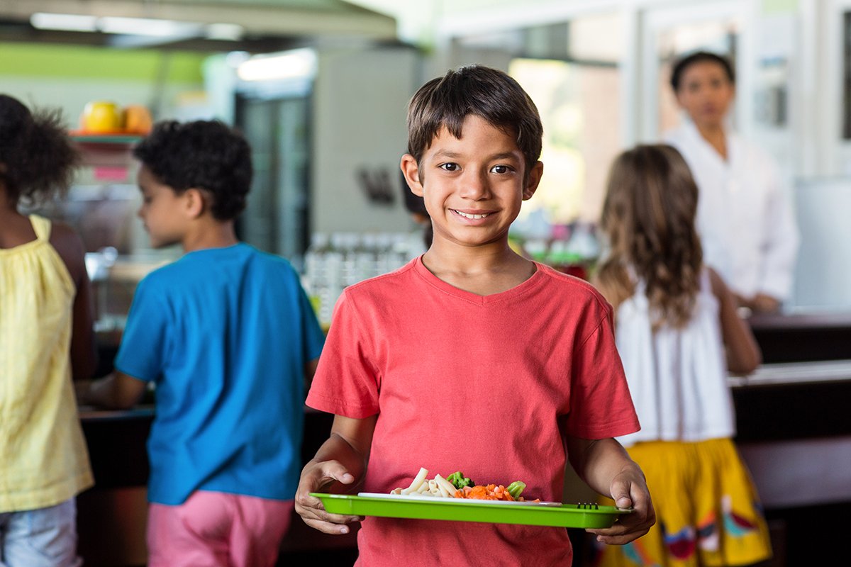 schoolboy holding food tray